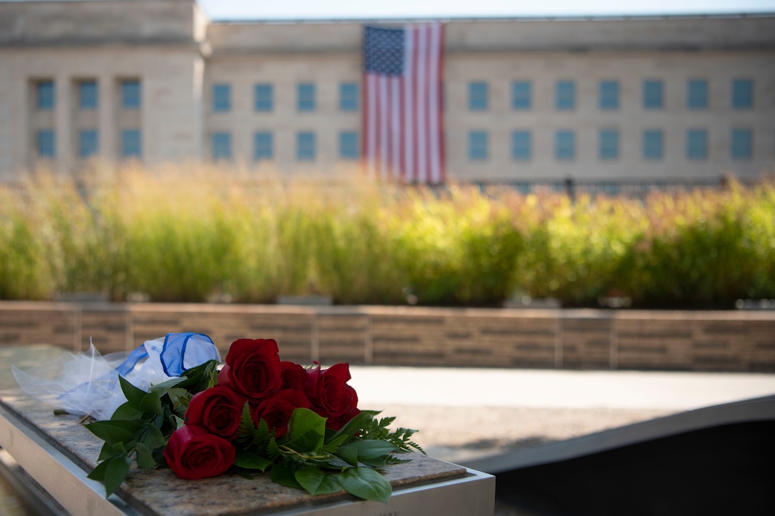 A bouquet of red roses lies on a bench outside the Pentagon.