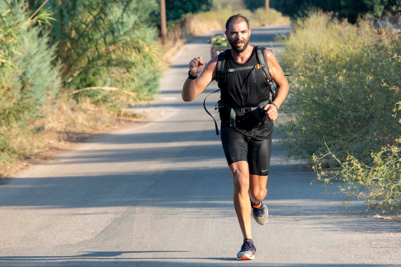 A hiker jogs along a trail.