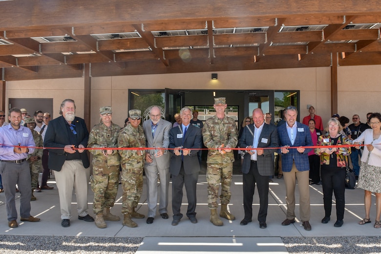 Leaders over the Gathering Place project cut a ribbon during a ceremony at Kirtland Air Force Base, N.M., Sept. 6, 2019. The Gathering Place hosts an advanced, renewable energy microgrid powered by solar panels that generates and distributes energy independently of the main power grid powering eight different building near Kirtland’s Family Camp. (U.S. Air Force photo by Airman 1st Class Austin J. Prisbrey)