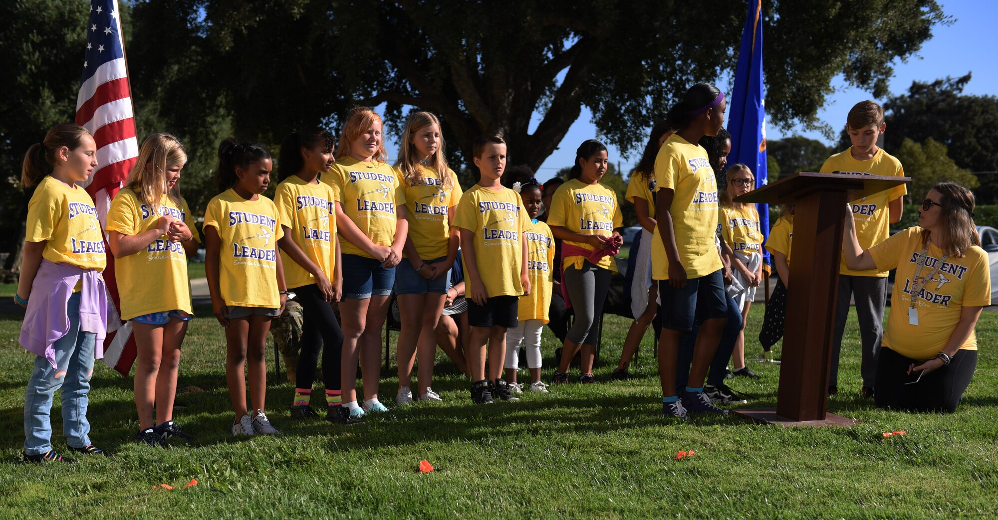 Children read a poem for those who died on 9/11 before the Remembrance Day Freedom Walk, Sept. 11, 2019, at Travis Air Force Base, California. The walk commemorated those who lost their lives on 9/11. (U.S. Air Force photo by Airman 1st Class Cameron Otte)