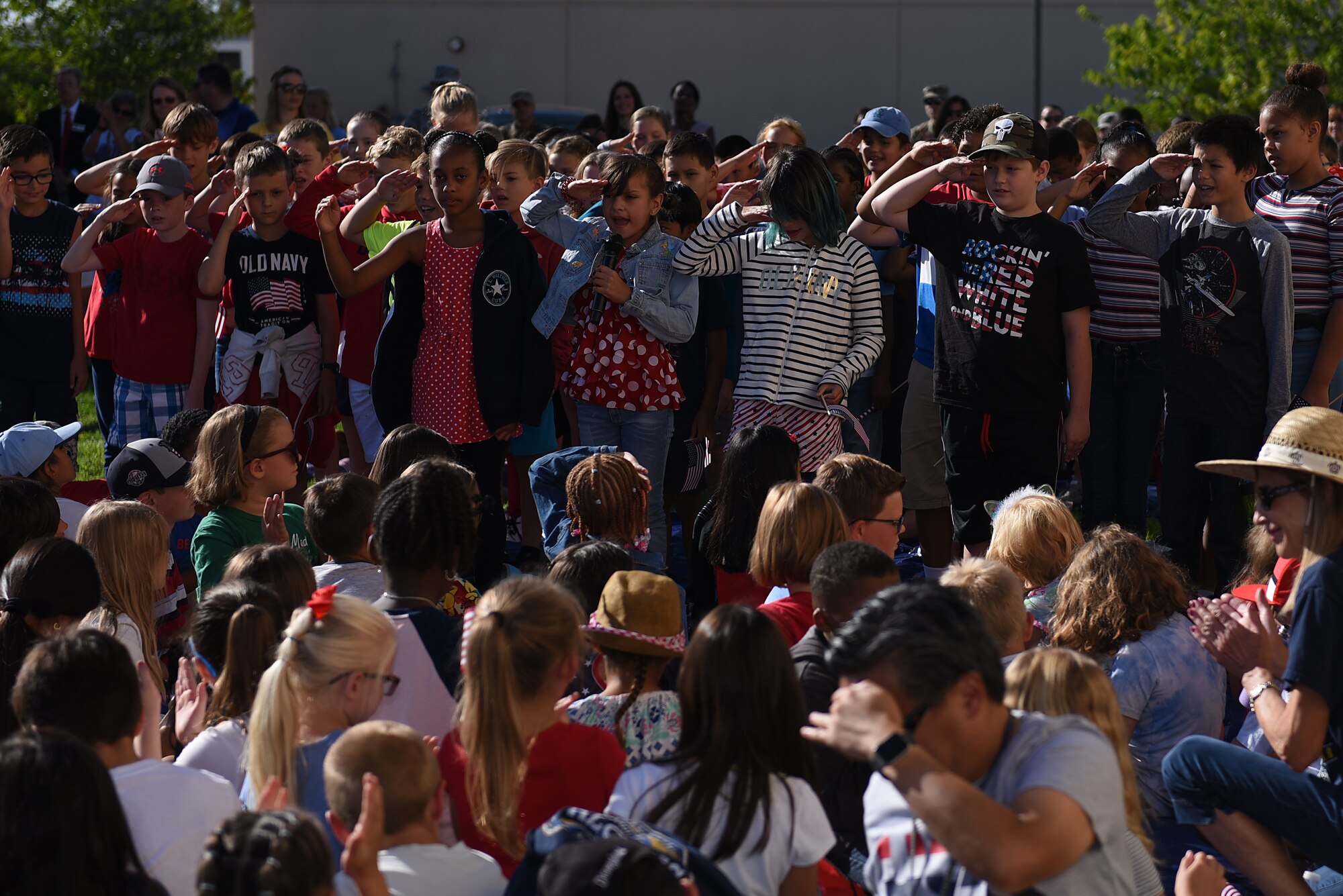 Children attending the Remembrance Day Freedom Walk sing “Proud to Be an American” while they salute, Sept. 11, 2019, at Travis Air Force Base, California. The walk commemorated those who lost their lives on 9/11. (U.S. Air Force photo by Airman 1st Class Cameron Otte)