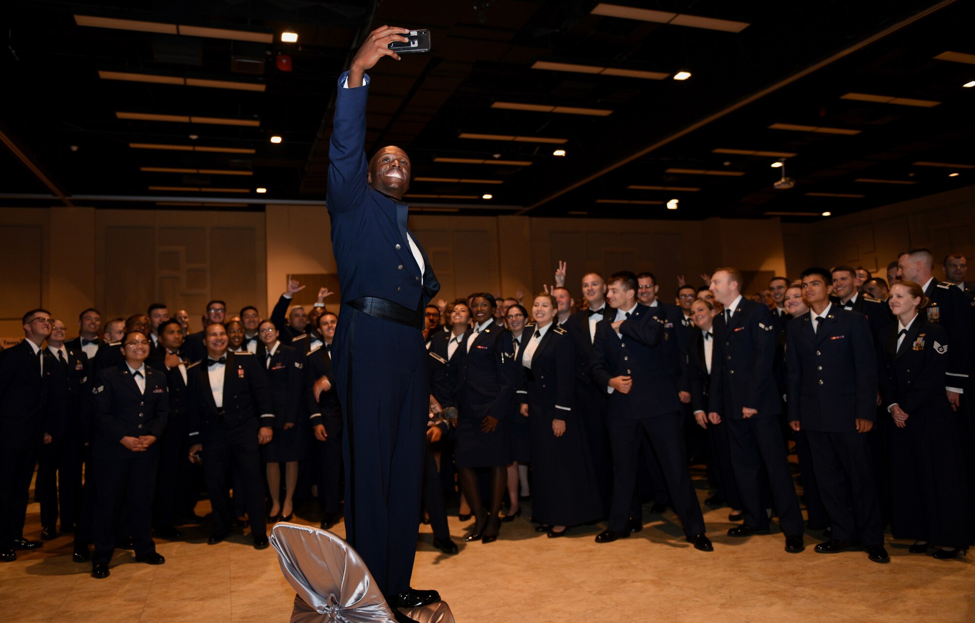 U.S. Air Force Chief Master Sgt. Lavor Kirkpatrick, 17th Training Wing command chief, takes a selfie with Goodfellow personnel at the 2019 Air Force Ball at the McNease Convention Center in San Angelo, Texas, September 7, 2019. The ball was a way to CONNECT with each other, as we GROW together and GO towards our future. (U.S. Air Force photo by Airman 1st Class Robyn Hunsinger/Released)