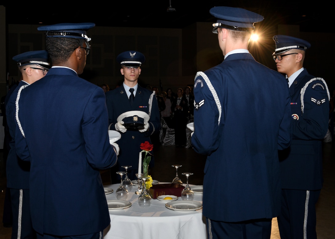 Goodfellow Honor Guard members place covers on the POW/MIA table during the 2019 Air Force Ball at the McNease Convention Center in San Angelo, Texas, September 7, 2019. The POW/MIA table has been a military tradition since the end of the Vietnam War, a place setting for one, a table for all. (U.S. Air Force photo by Airman 1st Class Robyn Hunsinger/Released)