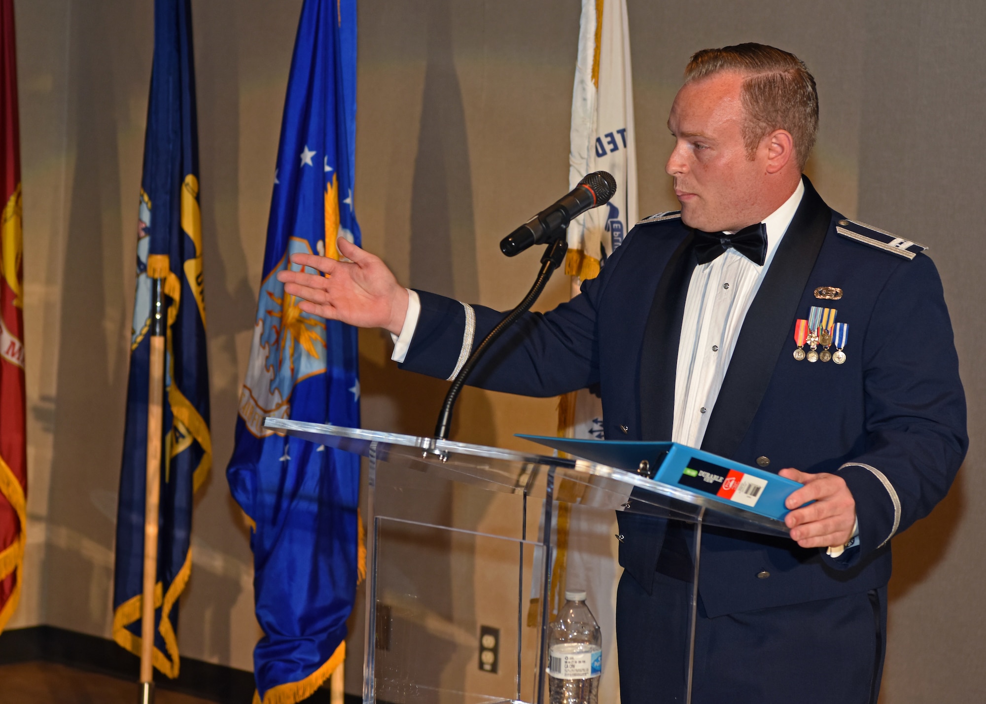 U.S. Air Force Capt. Michael Kanaan, Air Force co-chair for artificial intelligence, speaks on the future of AI and the Air Force at the 2019 Air Force Ball at the McNease Convention Center in San Angelo, Texas, September 7, 2019. Kanaan compared the AI race to the space race between the U.S. and Russia. (U.S. Air Force photo by Airman 1st Class Ethan Sherwood/Released)