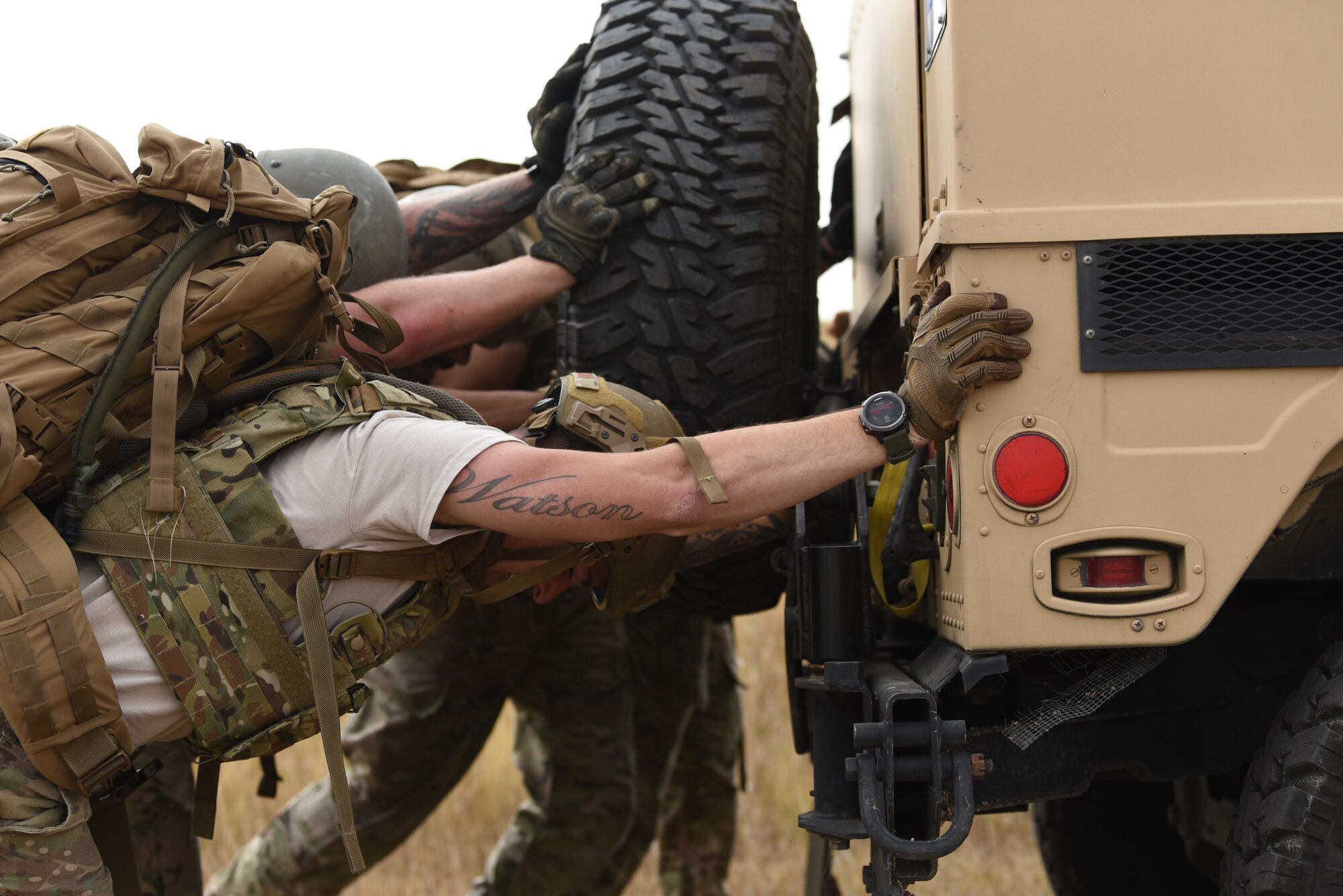 Security forces members from Team Guernsey show their strength during the HMMWV push at the annual Crow Creek Challenge Sept. 6, 2019, at F. E. Warren Air Force Base, Wyo.  They pushed the heavy vehicle down the intended path before reaching a small dip in the ground they had to overcome. After a brief moment of difficulty, they gave one final heave and got the vehicle over the small ditch to complete the task. (U.S. Air Force photo by Senior Airman Nicole Reed)