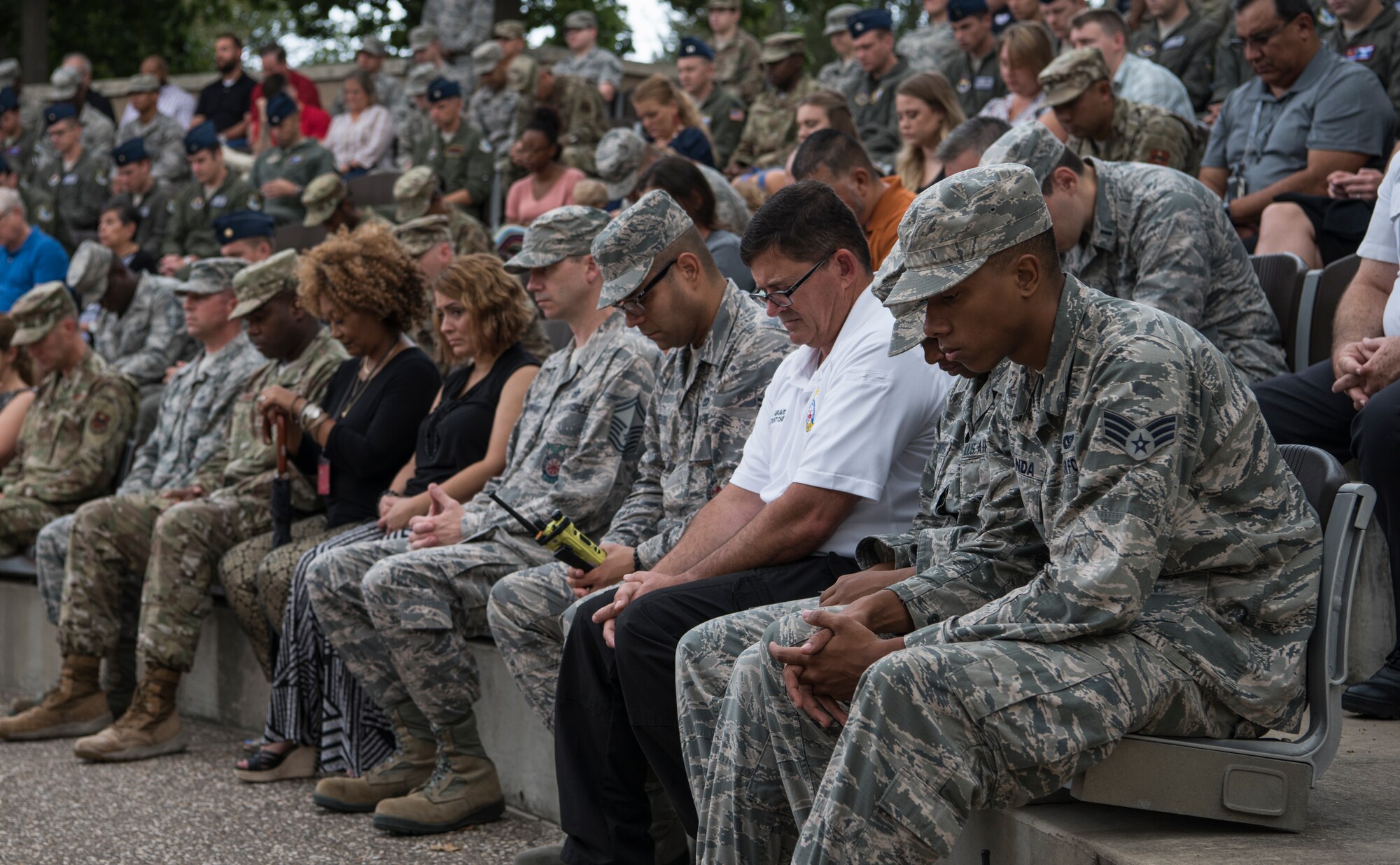 Airmen assigned to the 47th Flying Training Wing join in prayer during a 9/11 memorial ceremony at Laughlin Air Force Base, Texas, Sept. 11, 2019. Approximately 230 Laughlin Airmen gathered at the flag pole in remembrance of the nearly 3,000 people killed in the attacks. (U.S. Air Force photo by Staff Sgt. Benjamin N. Valmoja)