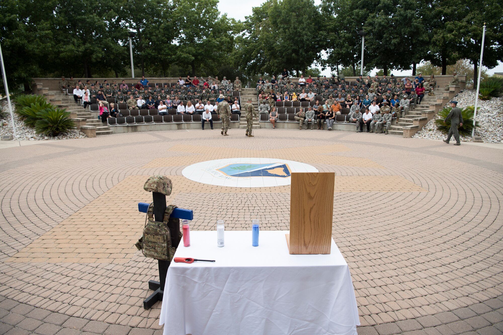 Airmen assigned to the 47th Flying Training Wing gather at Laughlin Air Force Base, Texas, Sept. 11, 2019, to honor those killed in the September 11th attacks 18 years ago. Approximately 230 Laughlin Airmen gathered at the flag pole in remembrance of the nearly 3,000 people killed in the attacks. (U.S. Air Force photo by Staff Sgt. Benjamin N. Valmoja)