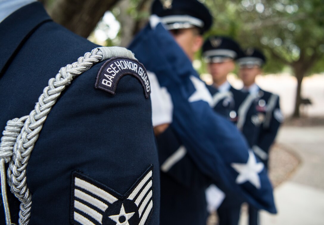 Laughlin Base Honor Guard members prepare to participate in a 9/11 memorial ceremony at Laughlin Air Force Base, Texas, Sept. 11, 2019. The flag was raised, then posted at half mast in remembrance of the nearly 3,000 people killed in the attacks of Sept. 11, 2001. (U.S. Air Force photo by Staff Sgt. Benjamin N. Valmoja)