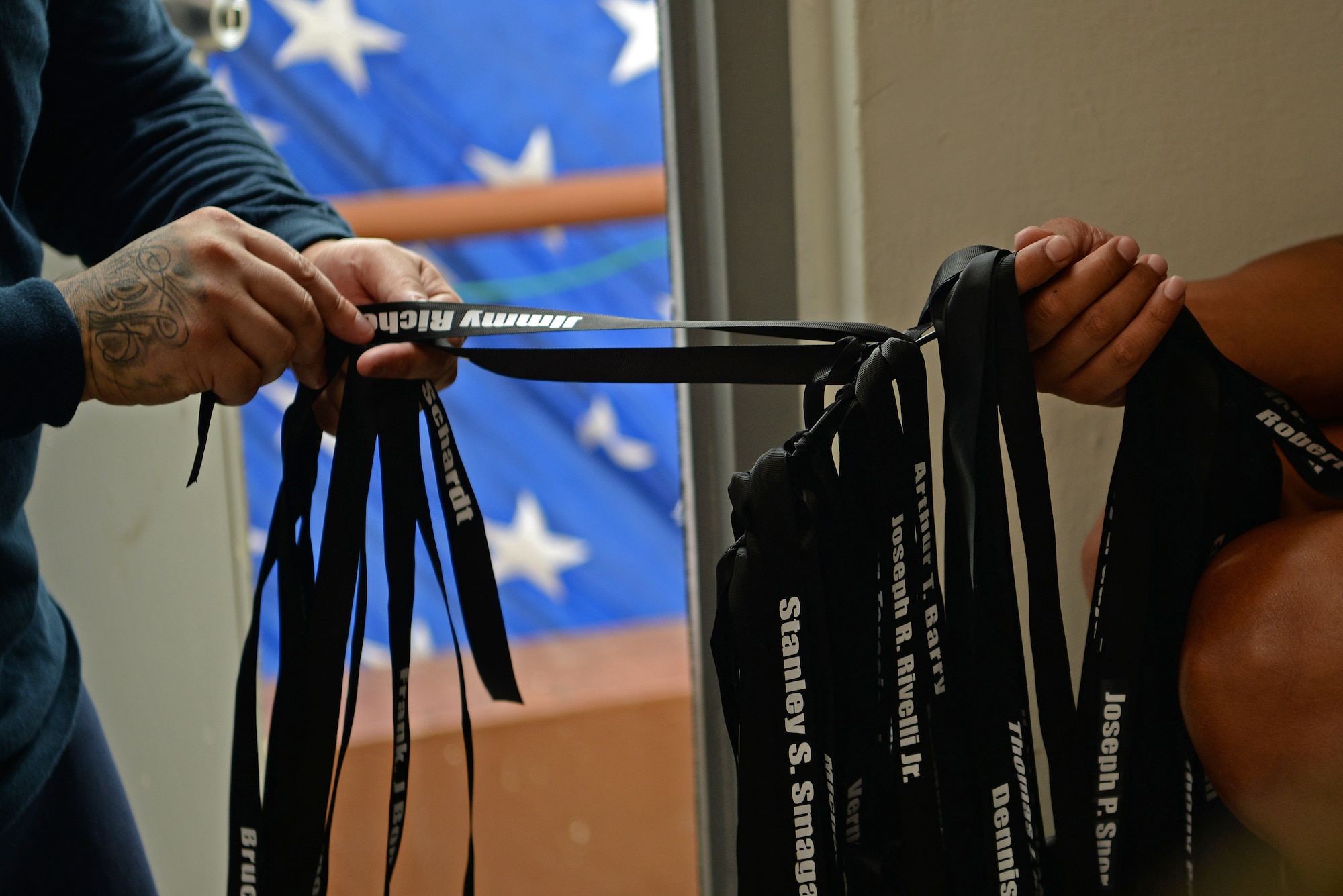 Ribbons labeled with one of the fallen fire fighters is clipped onto a ring during a September 11 memorial stair climb event on Andersen Air Force Base, Guam, Sept. 11, 2019.