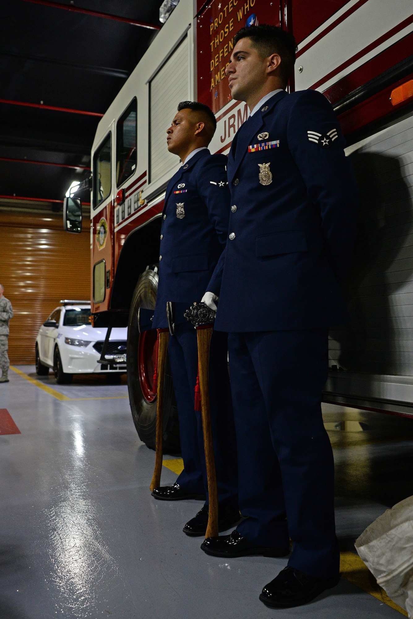 Two 36th Civil Engineer Squadron firefighters stand at attention during a September 11 memorial ceremony on Andersen Air Force Base, Guam, Sept. 11, 2019.