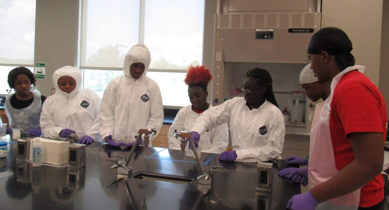 Students attending STEMversity in Milledgeville, Ga., work on a lab experiment with the help of Airman from the Air Force Technical Applications Center.  Each year, volunteers from the nuclear treaty monitoring center at Patrick AFB, Fla., provide expertise in the fields of science, technology, engineering and math to the summer campers at Central Georgia Technical College.  (U.S. Air Force photo by Stephanie Homitz)