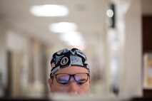 Col. (Dr.) Chad Hivnor, 59th Medical Specialty Squadron chief of laser medicine, reviews medical chart information before surgery