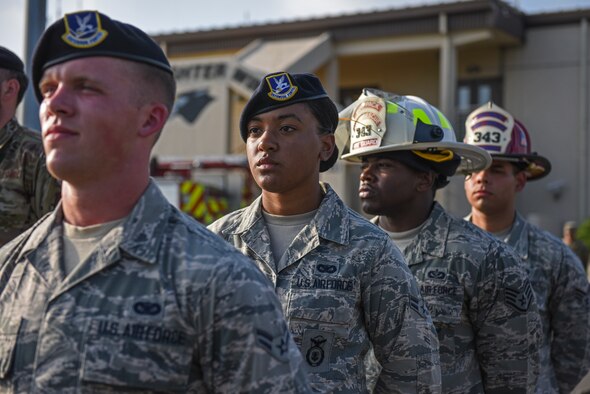 Airman 1st Class Aubrey Mathis, 8th Security Forces Squadron member, prepares for retreat during the September 11 Remembrance ceremony at Kunsan Air Base, Republic of Korea, Sept. 11, 2019. The ceremony included a ringing of a bell, flyover and flag folding in remembrance of the 2,977 people who lost their lives on Sept. 11, 2001. (U.S. Air Force photo by Staff Sgt. Mackenzie Mendez)