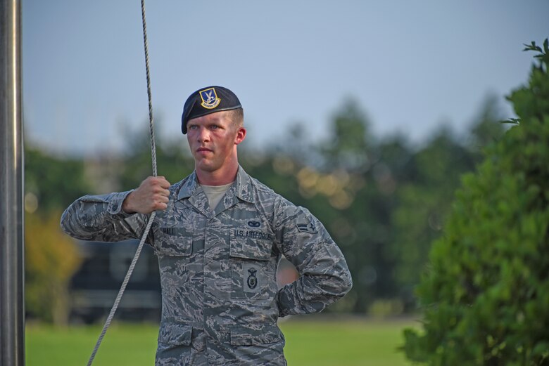 Airman 1st Class Harley Hall, 8th Security Forces Squadron member, prepares to lower the flag during the September 11 Remembrance ceremony at Kunsan Air Base, Republic of Korea, Sept. 11, 2019. The ceremony was held in remembrance of the 2,977 people who lost their lives on Sept. 11, 2001, in New York City, Washington, D.C., and outside Shanksville, Pennsylvania. (U.S. Air Force photo by Staff Sgt. Mackenzie Mendez)