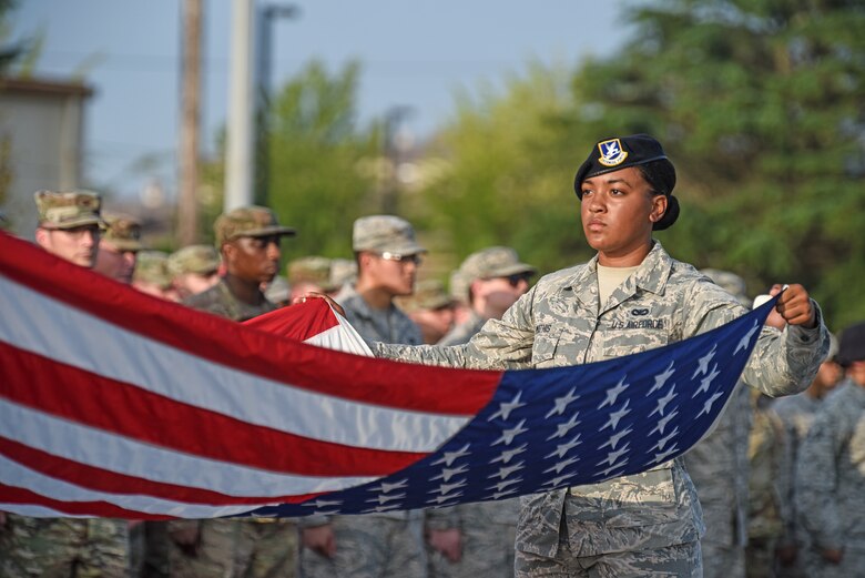 Airman 1st Class Aubrey Mathis, 8th Security Forces Squadron member, folds the American flag during the September 11 Remembrance ceremony at Kunsan Air Base, Republic of Korea, Sept. 11, 2019. The ceremony was held in remembrance of the 2,977 people who lost their lives on Sept. 11, 2001, in New York City, Washington, D.C., and outside Shanksville, Pennsylvania. (U.S. Air Force photo by Staff Sgt. Mackenzie Mendez)