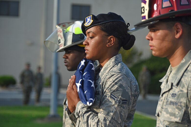 U.S. Air Force Airman 1st Class Aubrey Mathis, 8th Security Forces Squadron member, carries the folded American flag during the September 11 Remembrance ceremony at Kunsan Air Base, Republic of Korea, Sept. 11, 2019. The ceremony was held in remembrance of the 2,977 people who lost their lives on Sept. 11, 2001, in New York City, Washington, D.C., and outside Shanksville, Pennsylvania. (U.S. Air Force photo by Staff Sgt. Mackenzie Mendez)
