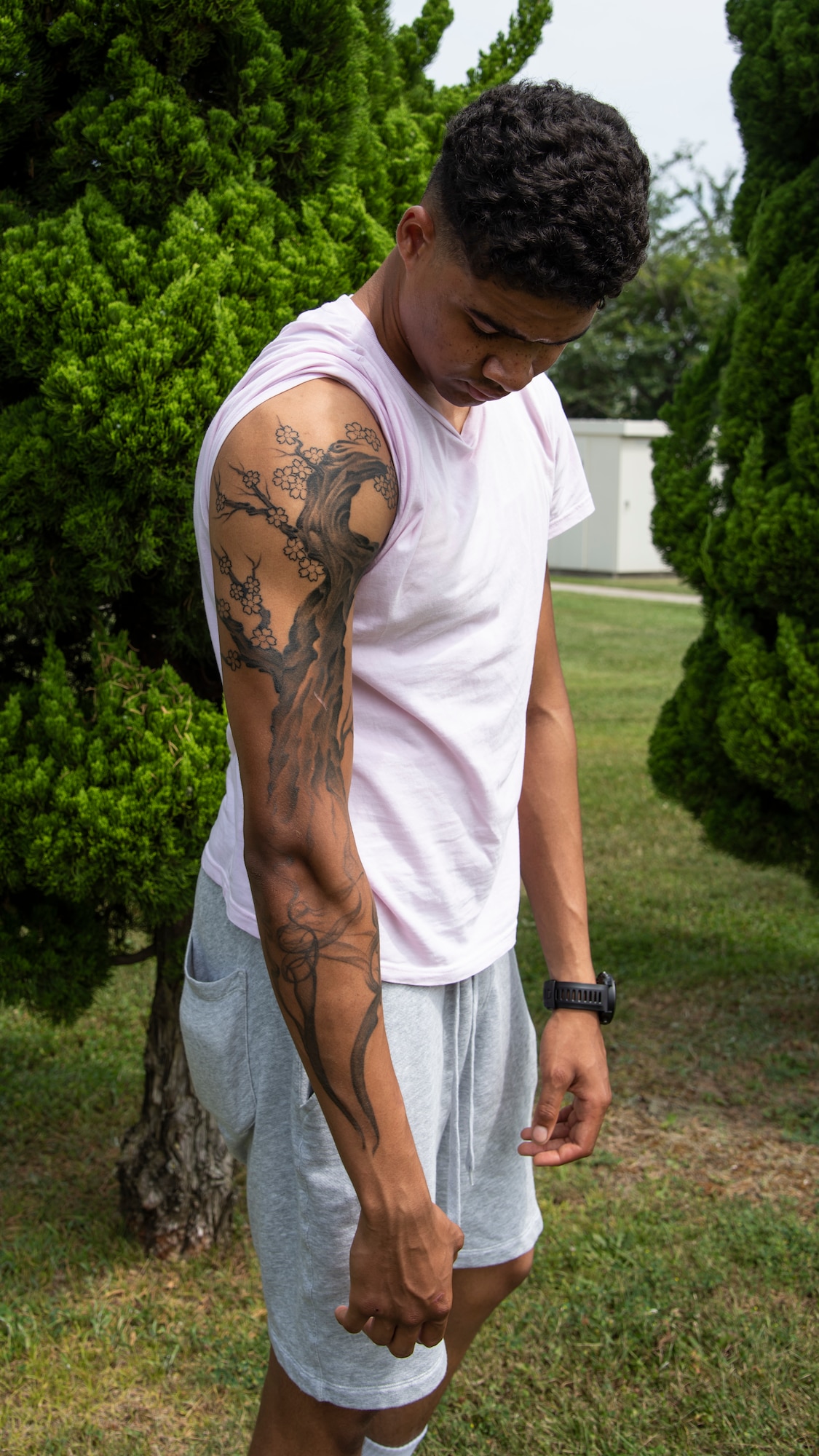 U.S. Air Force Airman 1st Class D’Andre Daniels, a 35th Aircraft Maintenance Squadron crew chief, reveals his tattoos at Misawa Air Base, Japan, Aug. 8, 2019. For this one individual in particular, his tattoos are a reminder of where he used to be, where he never wants to be again and where he needs to go. (U.S. Air Force photo by Airman 1st China M. Shock)