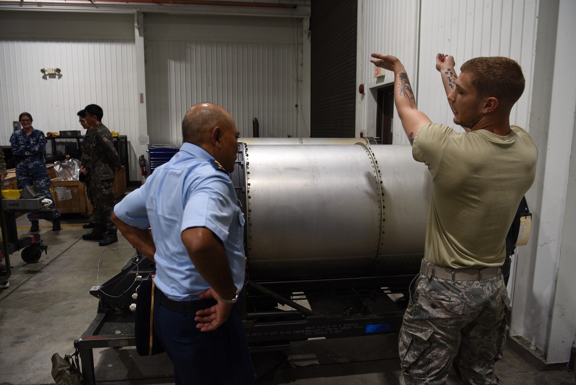 U.S. Air Force Airman 1st Class Zachary Baker, an avionics weapon maintenance back-shop troop assigned to the 51st Munitions Squadron, explains how the A-10 Thunderbolt II weapon system is loaded into the aircraft to Indonesian air force officers during the 2019 Logistics and Safety Symposium held at Osan Air Base, Republic of Korea, Sept. 5, 2019.