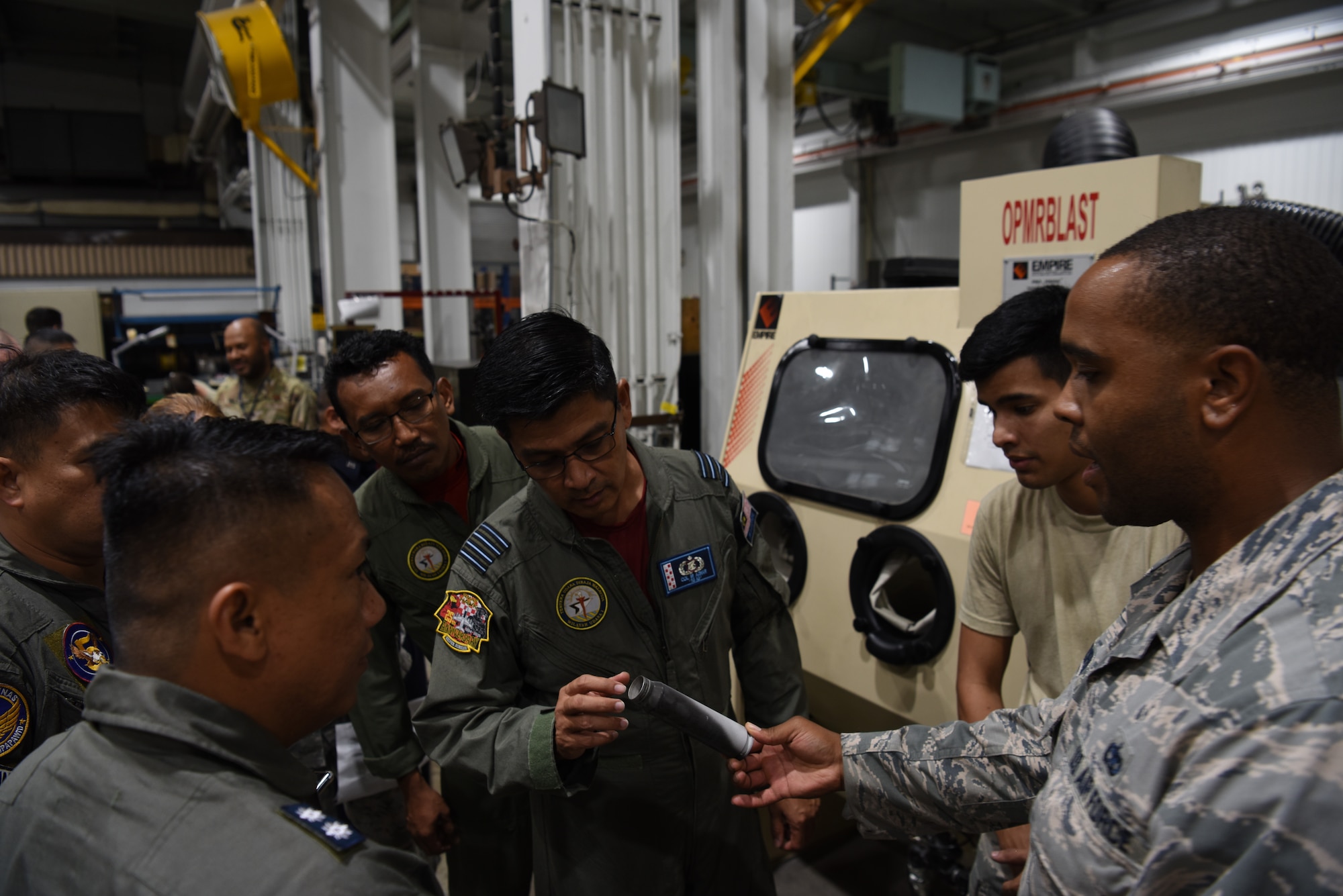 Royal Malaysian air force Col Ir. Azhar bin Idris inspects a 30mm shell after a restoration demonstration during the 2019 Logistics and Safety Symposium held at Osan Air Base, Republic of Korea, Sept. 5, 2019.