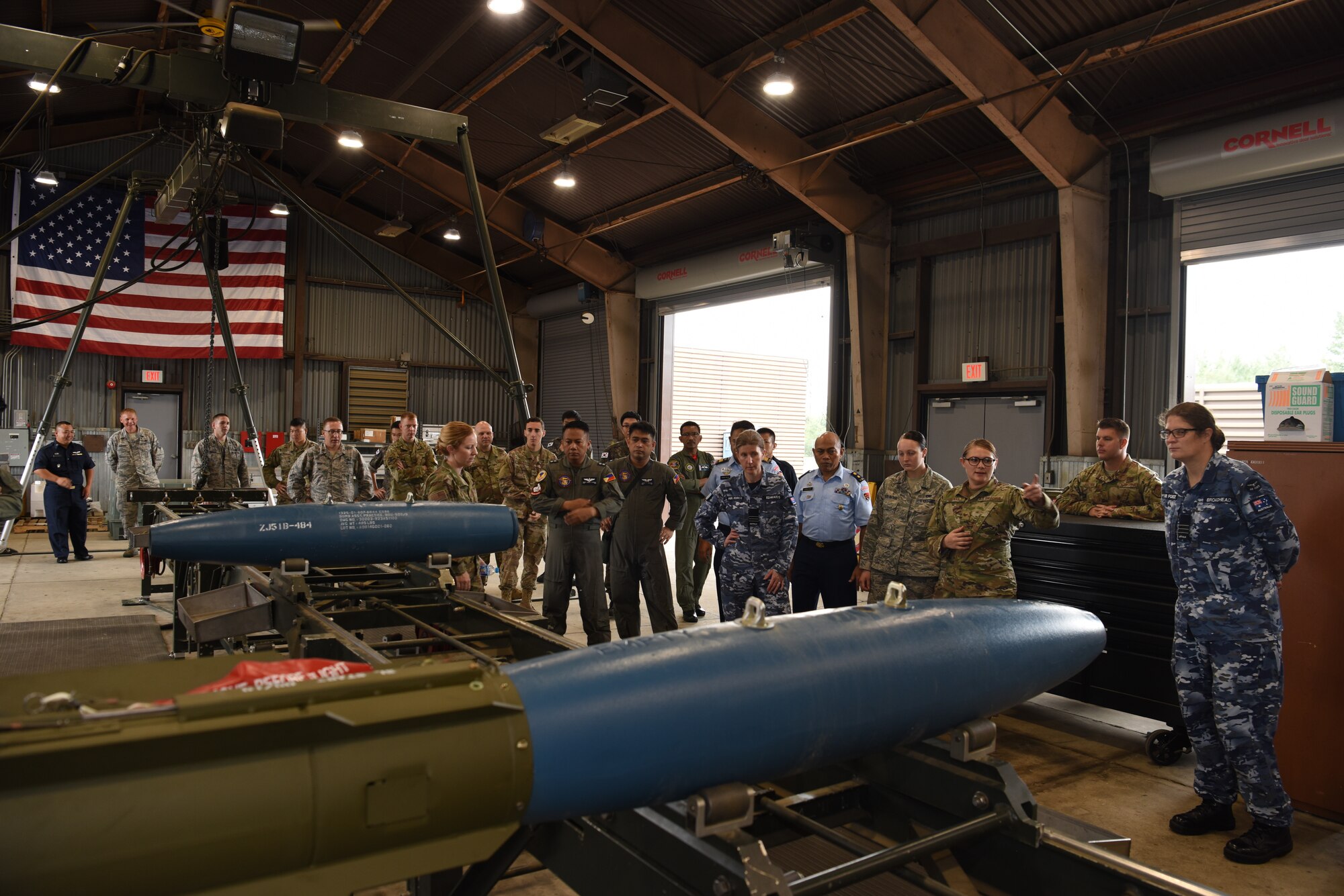 U.S. Air Force Staff Sgt. Britney Galvan, a conventional maintenance crew chief assigned to the 51st Munitions Squadron, briefs partner nations on munition loading procedures during the 2019 Logistics and Safety Symposium held at Osan Air Base, Republic of Korea, Sept. 6, 2019.