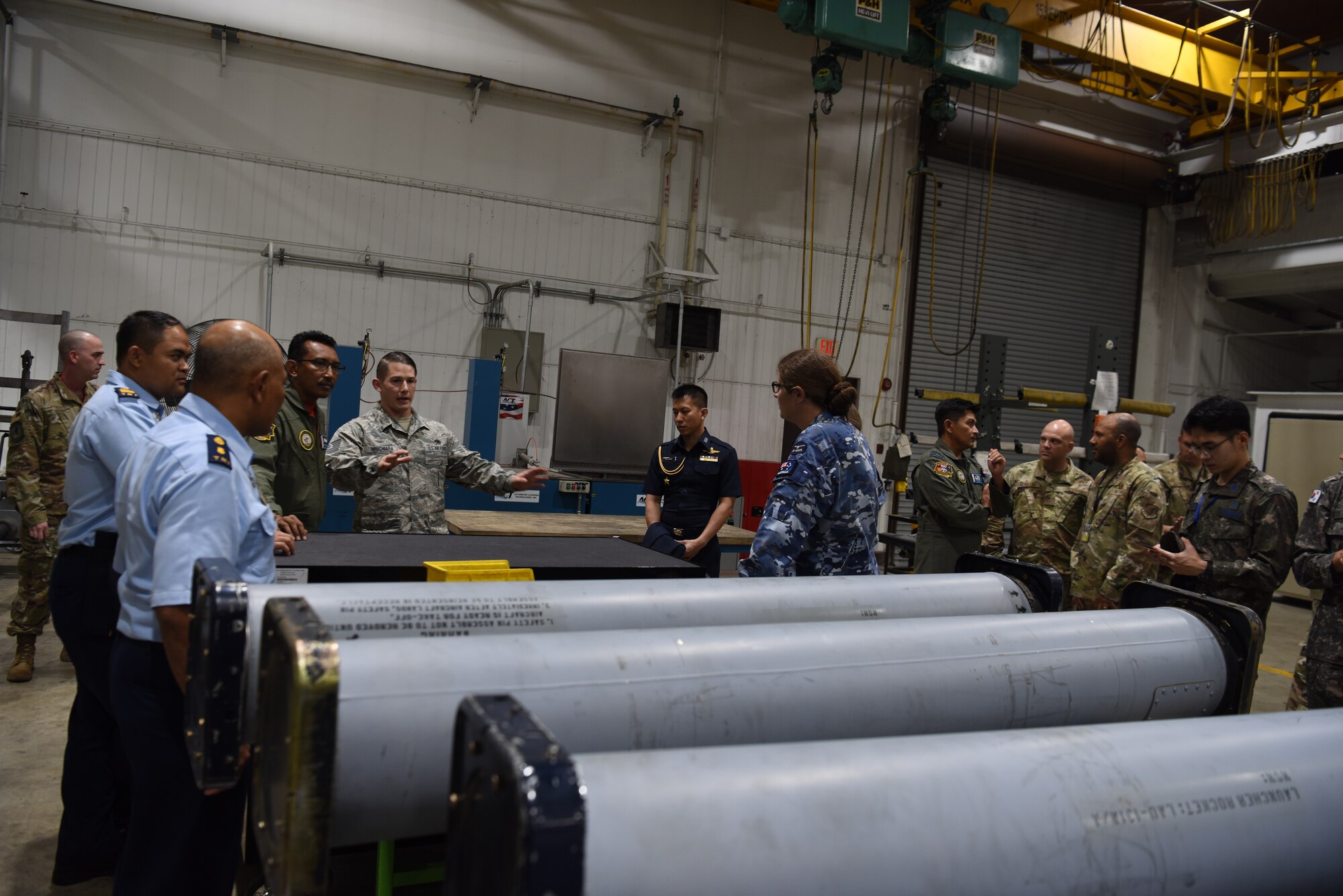 U.S. Air Force Tech. Sgt. Nicholas Mischiara, an armament maintenance floor supervisor assigned to the 51st Munitions Squadron, explains the capabilities and purpose of the back-shop to partner nations attending the 2019 Logistics and Safety Symposium held at Osan Air Base, Republic of Korea, Sept. 5, 2019.