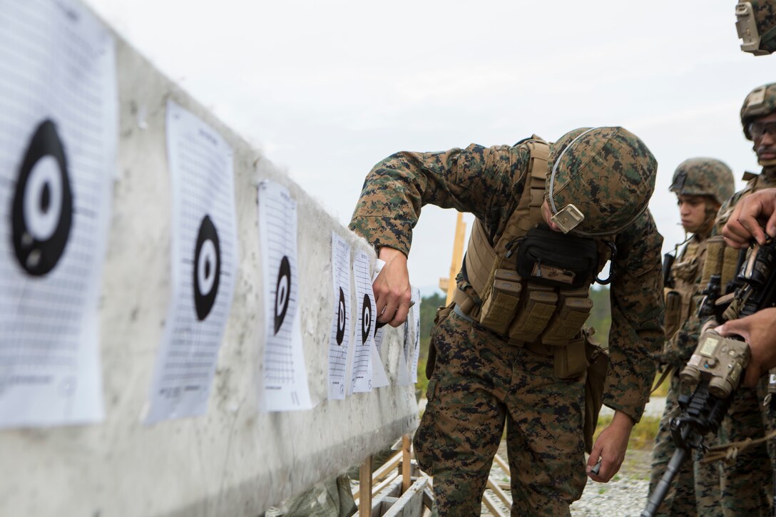 A U.S. Marine with Marine Rotational Force-Europe 19.2, Marine Forces Europe and Africa, evaluates target impacts and makes corrections during a rifle range in Setermoen, Norway, Aug. 28, 2019.