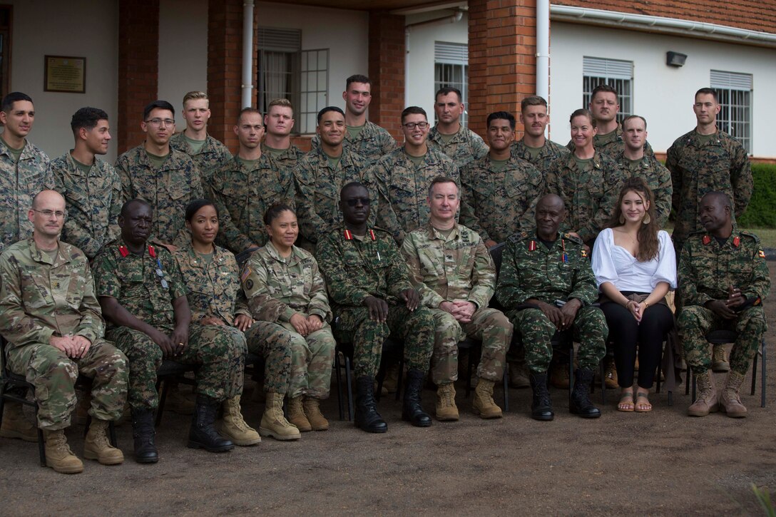 Uganda People's Defense Force Soldiers, a U.S. Embassy member, a U.S. Soldier, and U.S. Marines and Sailors with Special Purpose Marine Air-Ground Task Force-Crisis Response-Africa 19.2, Marines Forces Europe and Africa, pose for a group photo during a closing ceremony at Camp Jinja, Uganda, Aug. 30, 2019.