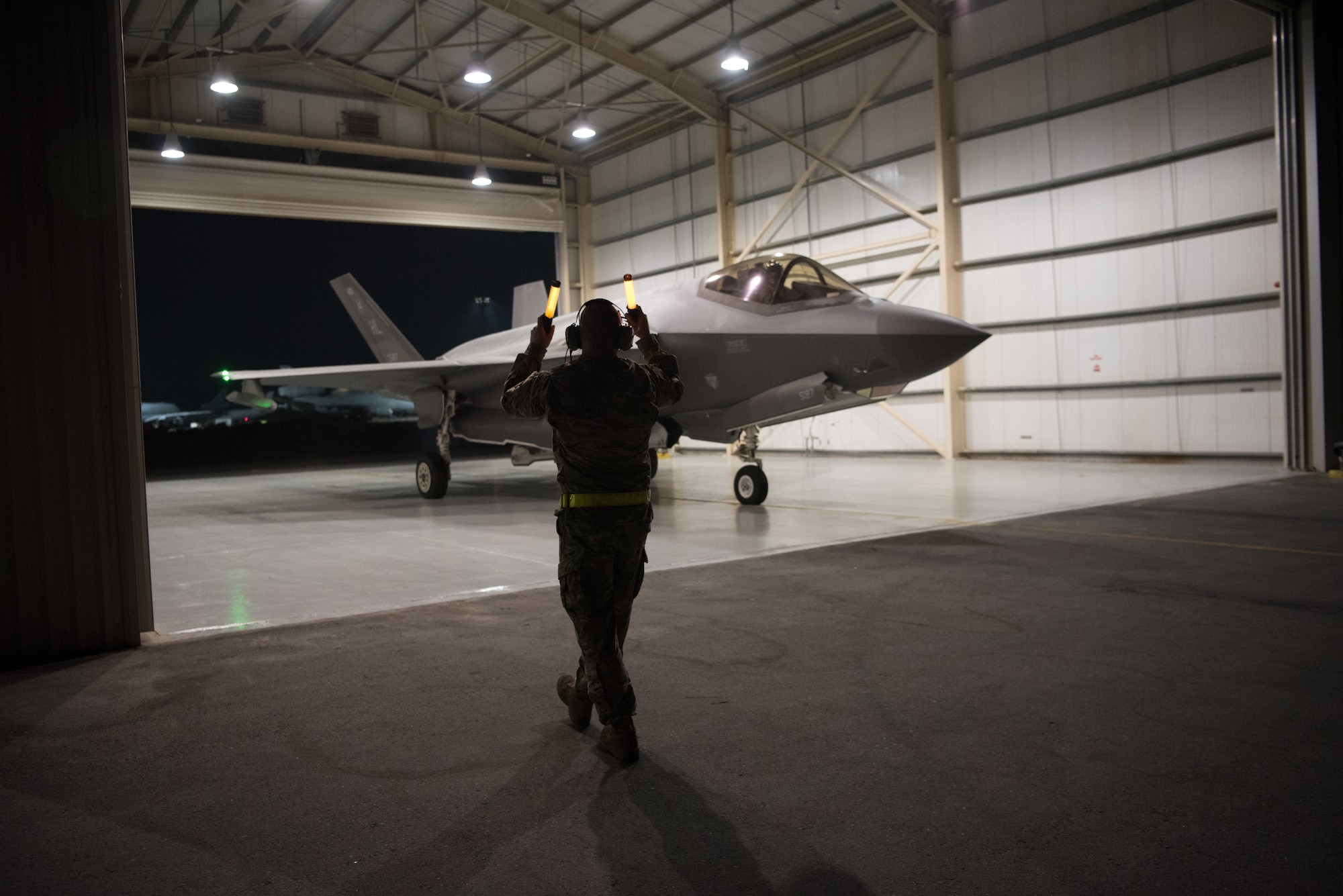 A U.S. Air Force F-35A Lightning II aircraft, assigned to the 4th Expeditionary Fighter Squadron, is marshalled from the hangar Sept. 10, 2019, at Al Dhafra Air Base, United Arab Emirates. The F-35A conducted a Coalition and Iraqi Counter-Terrorism Service air strike in the Salah ad Din Province, Iraq, Sept. 10, in support of Iraqi ground force clearing operations.  (U.S. Air Force photo by Tech. Sgt. Jocelyn A. Ford)