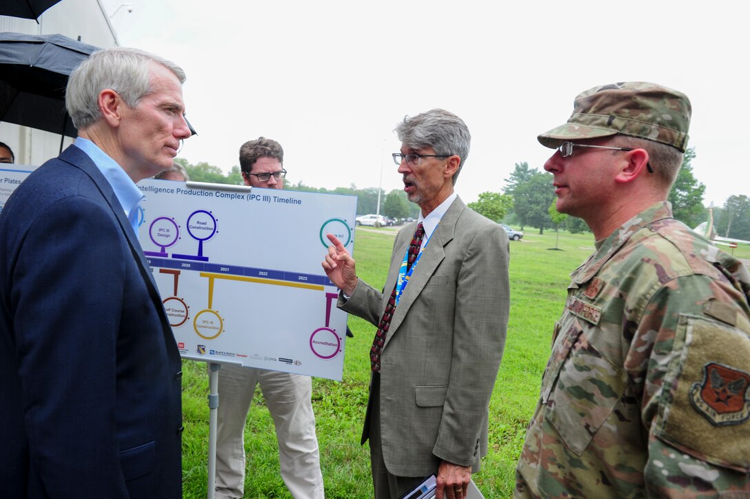 David Bek, Logistics and Facilities Directorate director, and Col. Parker H. Wright, National Air and Space Intelligence Center commander, provide an update on the NASIC facility expansion plan to Sen. Robert Portman, Aug 27. NASIC was one stop in Portman’s visit to Wright-Patterson. (U.S. Air Force photo by Senior Airman Michael Hunsaker)