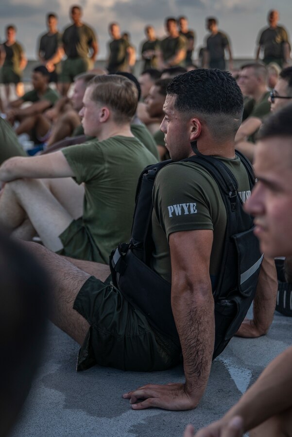 U.S. Marine Corps Sgt. Alexander Granja, administration specialist with the Installation Personnel Administration Center, at Marine Forces Reserve, listens to a speech about 9/11 after a Total Force Fitness event at Marine Corps Support Facility New Orleans, Sept. 11, 2019. This was part of a MARFORRES Total Force Fitness event inspired by the 18th anniversary of 9/11 and the efforts of the first responders at the World Trade Center. The exercise consisted of Marines ascending and descending a five story stairwell 11 times, resulting in a total of 110 stories, which is equivalent to the height of the World Trade Center. (U.S. Marine Corps photo by Pfc. Leslie Alcaraz)