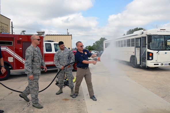 Steve Young, VIA Metropolitan Transit vice president of information technology, experiences discharging a fire hose during a tour of the 433rd Mission Support Group at Joint Base San Antonio-Lackland, Texas Sept. 7, 2019.