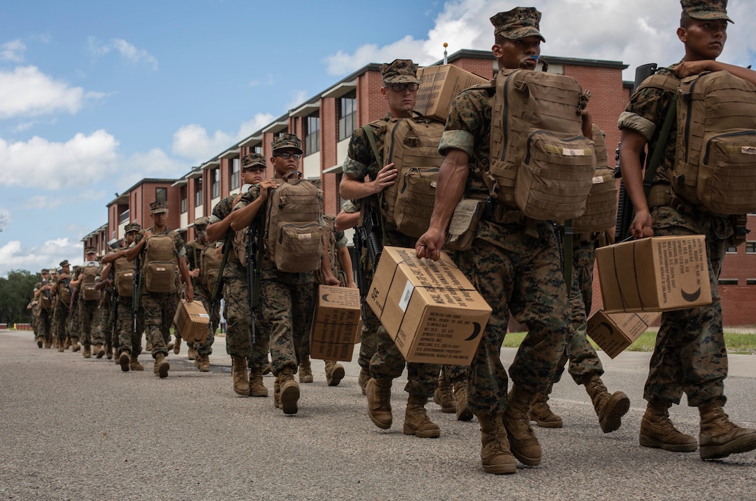 Marine Corps Recruit Depot Parris Island recruits carry meals-ready-to-eat ahead of their evacuation to Marine Corps Logistics Base Albany, Ga. ahead of Hurricane Dorian, Sept. 3, 2019. Troop Support provided more than 96,000 meals to various Department of Defense customers in support of the hurricane relief efforts. (U.S. Marine Corps photo by Sgt. Dana Beesley)