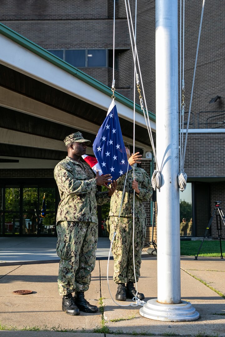 Chief Selects Deshawn Oliver and Nathaniel Pulcar raises the National Ensign during a Patriots Day ceremony at Norfolk Naval Shipyard Sept. 11, 2019.