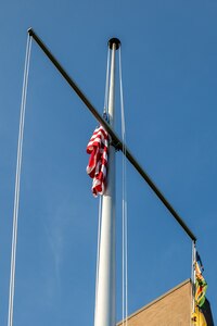 The National Ensign is lowered to half mast at Norfolk Naval Shipyard in memory of those who were lost on Sept. 11, 2001.