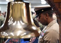 Chief Hospital Corpsman Darnell Mason bows his head for the invocation during a chief petty officer pinning ceremony held on board Naval Support Activity Bahrain. 39 Sailors from U.S. Naval Forces Central Command, Naval Support Activity Bahrain, and commands located throughout the U.S. 5th Fleet area of operations received their anchors.