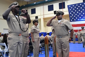 Chief Yeoman Justin Tilley renders a salute to the sideboys during a chief petty officer pinning ceremony held on board Naval Support Activity Bahrain. 39 Sailors from U.S. Naval Forces Central Command, Naval Support Activity Bahrain, and commands located throughout the U.S. 5th Fleet area of operations received their anchors.