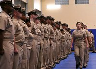 Chief petty officer selectees sing Anchors Aweigh as they make their entrance into a chief petty officer pinning ceremony held on board Naval Support Activity Bahrain. 39 Sailors from U.S. Naval Forces Central Command, Naval Support Activity Bahrain, and commands located throughout the U.S. 5th Fleet area of operations received their anchors.