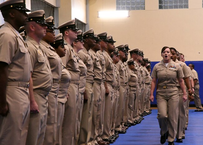 Chief petty officer selectees sing Anchors Aweigh as they make their entrance into a chief petty officer pinning ceremony held on board Naval Support Activity Bahrain. 39 Sailors from U.S. Naval Forces Central Command, Naval Support Activity Bahrain, and commands located throughout the U.S. 5th Fleet area of operations received their anchors.