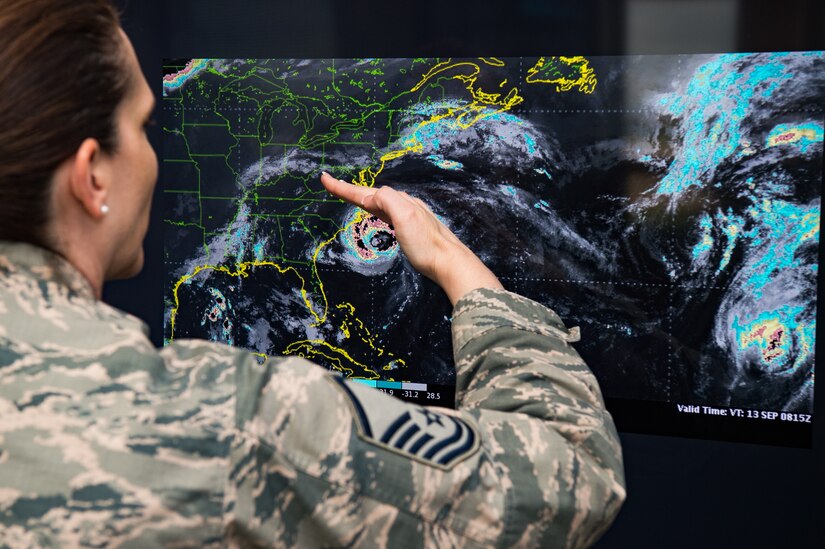 U.S. Air Force Master Sgt. Ashley Weatherly, flight chief for the1st Operational Support Squadron Weather Flight, demonstrates the path of Hurricane Florence at Joint Base Langley-Eustis, Virginia, Aug. 21, 2019.