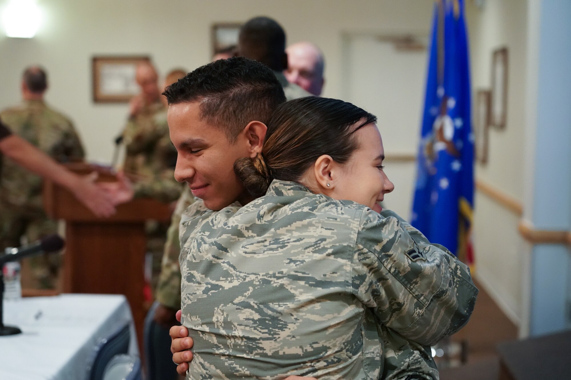 Airman Alfonso Santiago, 90th Medical Group medical technician and another Airman hug after a story telling event Sept. 10 2019, at F.E. Warren Air Force Base, Wyo. The event was hosted on Suicide Prevention Day and aimed to raise awareness about suicide prevention. (U.S. Air Force photo by Joseph Coslett)