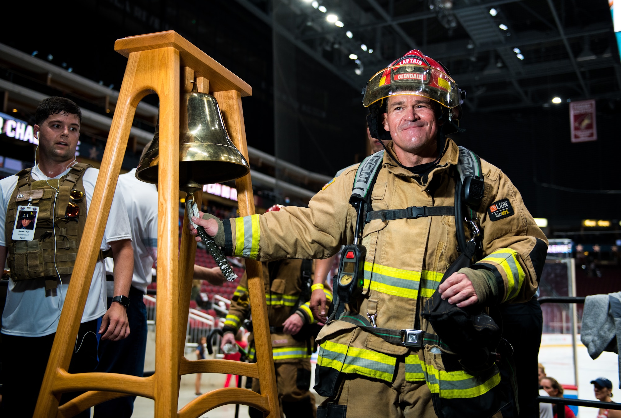 A firefighter from the Glendale Fire Department rings a bell during the 9/11 Tower Challenge Sept. 11, 2019, at the Gila River Arena, Glendale, Ariz.