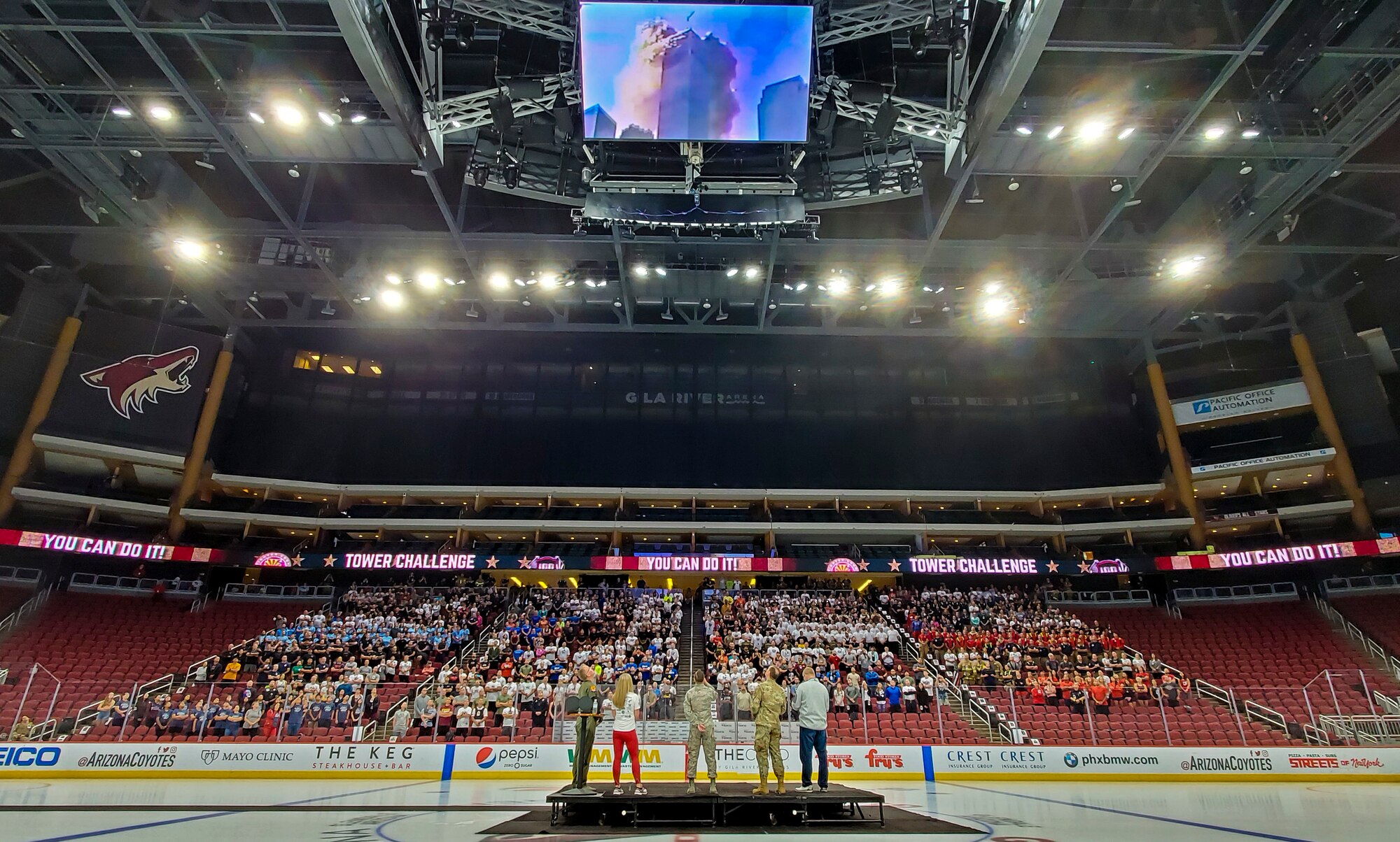 Brig. Gen. Todd Canterbury, front left, 56th Fighter Wing commander, along with military and local community members watch a video during the 9/11 Tower Challenge Sept. 11, 2019, at the Gila River Arena, Glendale, Ariz.