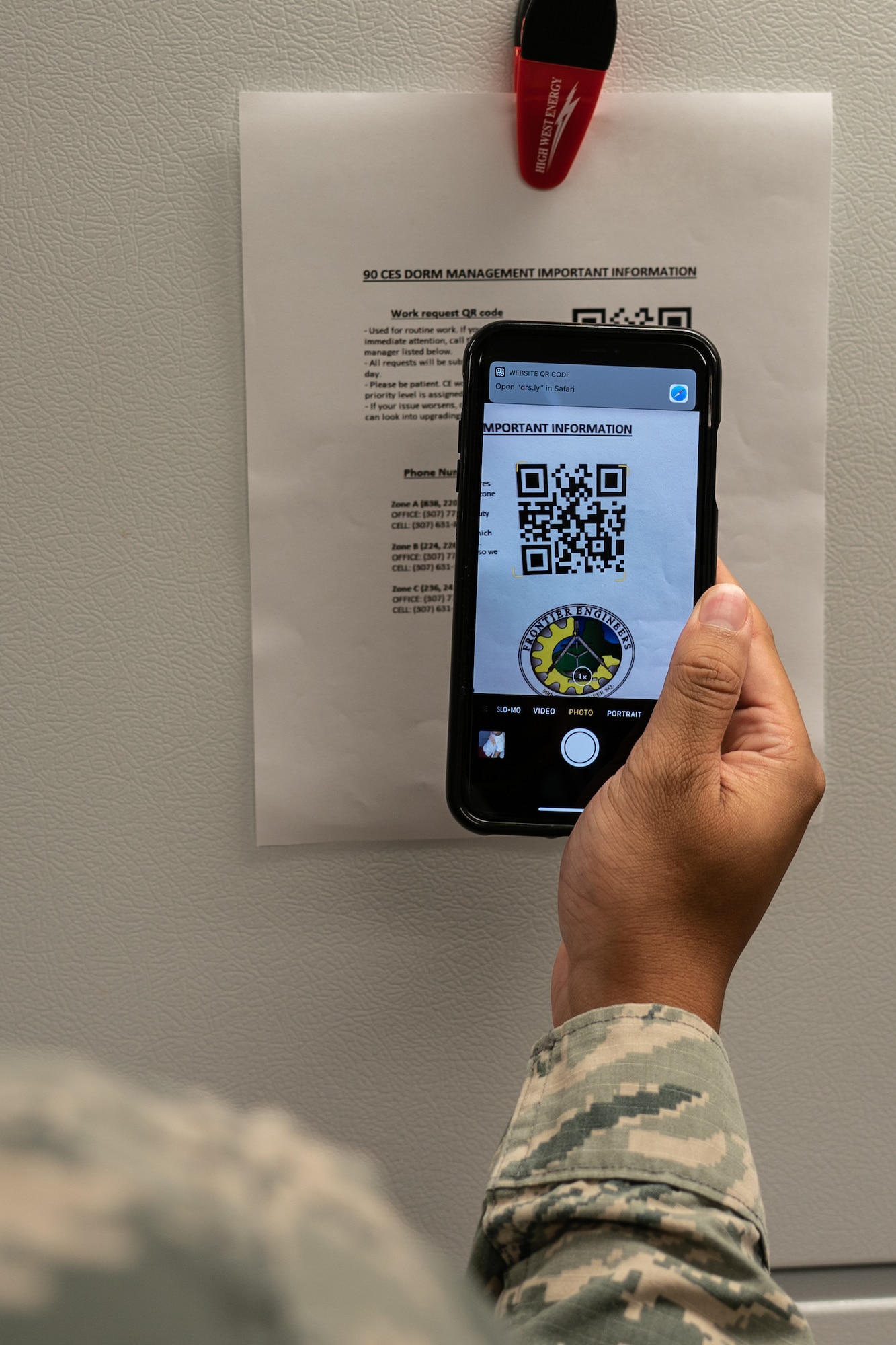 Senior Airman Wil Yau, 90th Communications Squadron client systems technician and originally from Kissimmee, Fla., demonstrates the quick response code dormitory work order process Sept. 10, 2019, at F.E. Warren Air Force Base, Wyo. Yau and the dormitory management team created an improved dorm maintenance work order process to make it more convenient for Airmen to report issues. (U.S. Air Force photo by Joseph Coslett)