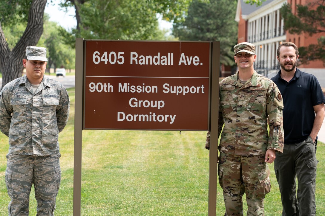 Senior Airman Wil Yau, 90th Communications Squadron client systems technician and originally from Kissimmee, Fla., Staff Sgt. Kenneth Rosenquist, 90th Civil Engineer Squadron airman dorm leader and Christopher Mull, 90 CES unaccompanied housing manager, pose for a photo outside the 90th Mission Support Group Dormitory Sept. 10, 2019, at F.E. Warren Air Force Base, Wyo. Yau and the dormitory management team created an improved dorm maintenance work order process to make it more convenient for Airmen to report issues. (U.S. Air Force photo by Joseph Coslett)
