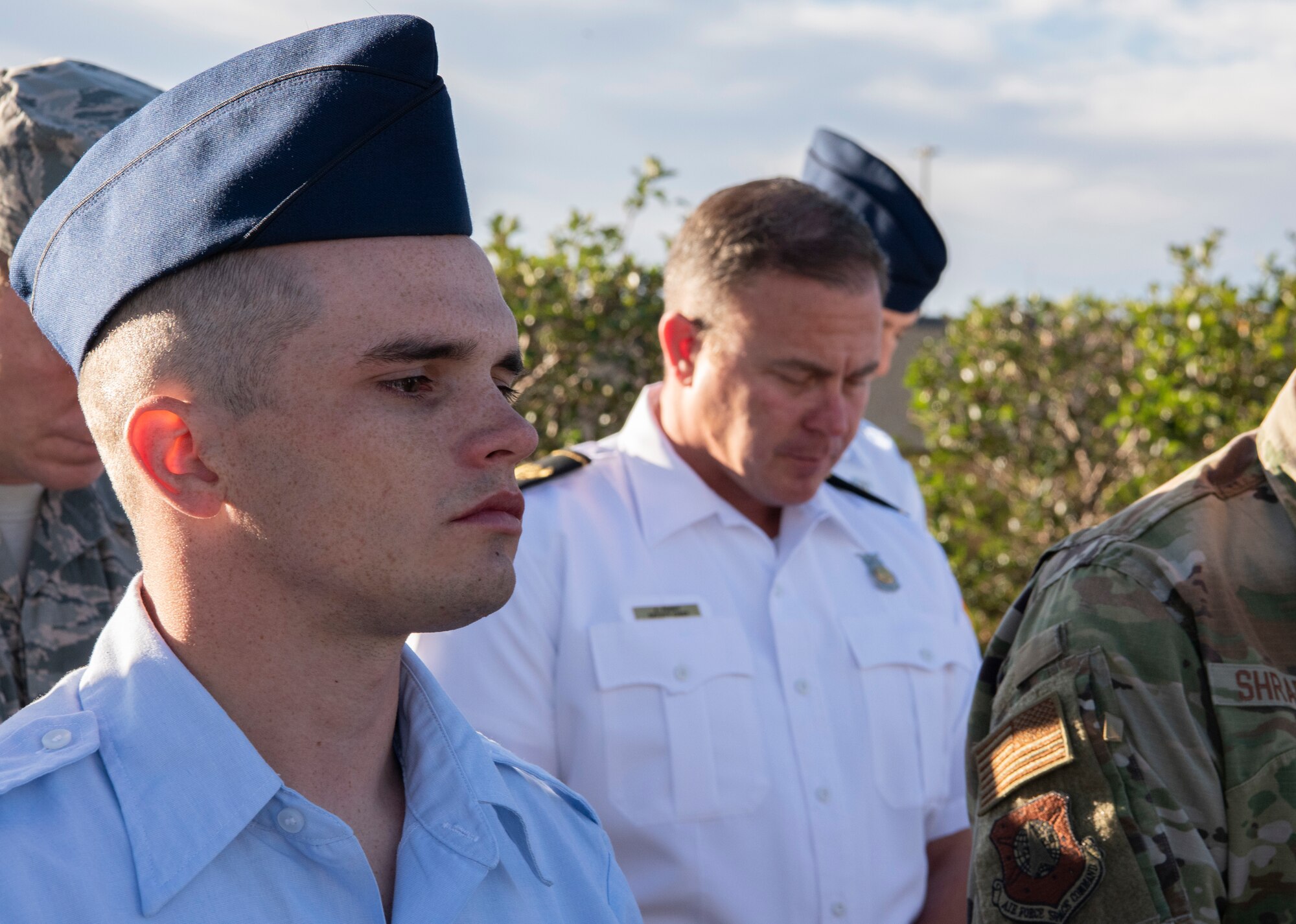 Staff. Sgt. Robert Cook, 50th Space Wing safety office noncommissioned officer in charge, listens to an invocation at a wreath laying ceremony at Schriever Air Force Base, Colo. Sept. 11, 2019. Airmen gathered to remember the 2,996 people who lost their lives in the attacks on Sept 11, 2019. (U.S. Air Force photo by Airman 1st Class Jonathan Whitely)