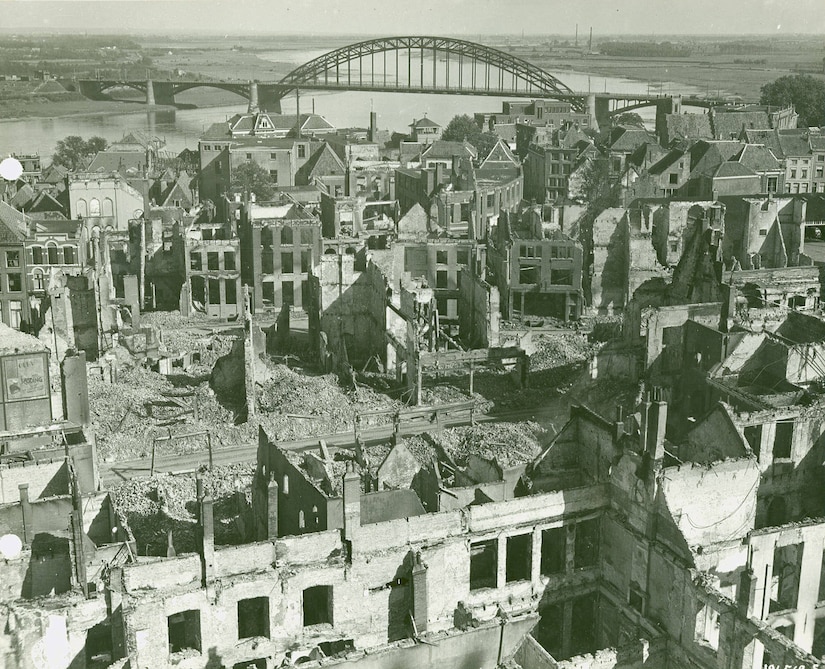An aerial view of a town in which many of the buildings have been destroyed.