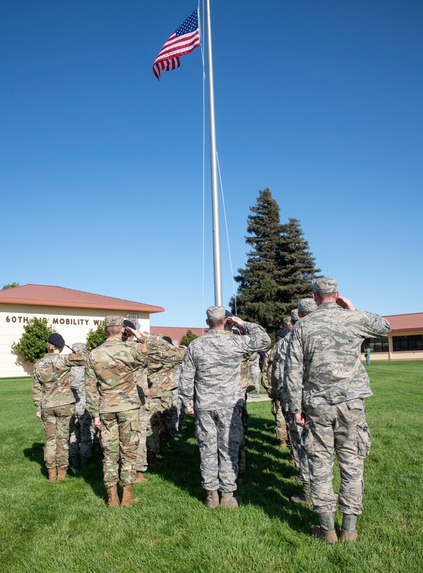 U.S. Air Force first responders from 60th Security Forces Squadron and the 60th Civil Engineer Squadron render a salute during a 9/11 Memorial Retreat Ceremony Sept. 11, 2019, at Travis Air Force Base, California. The ceremony honored the victims of the terrorist attacks on Sept. 11, 2001 and the first responders who risked their lives to save them. (U.S. Air Force photo by Heide Couch)