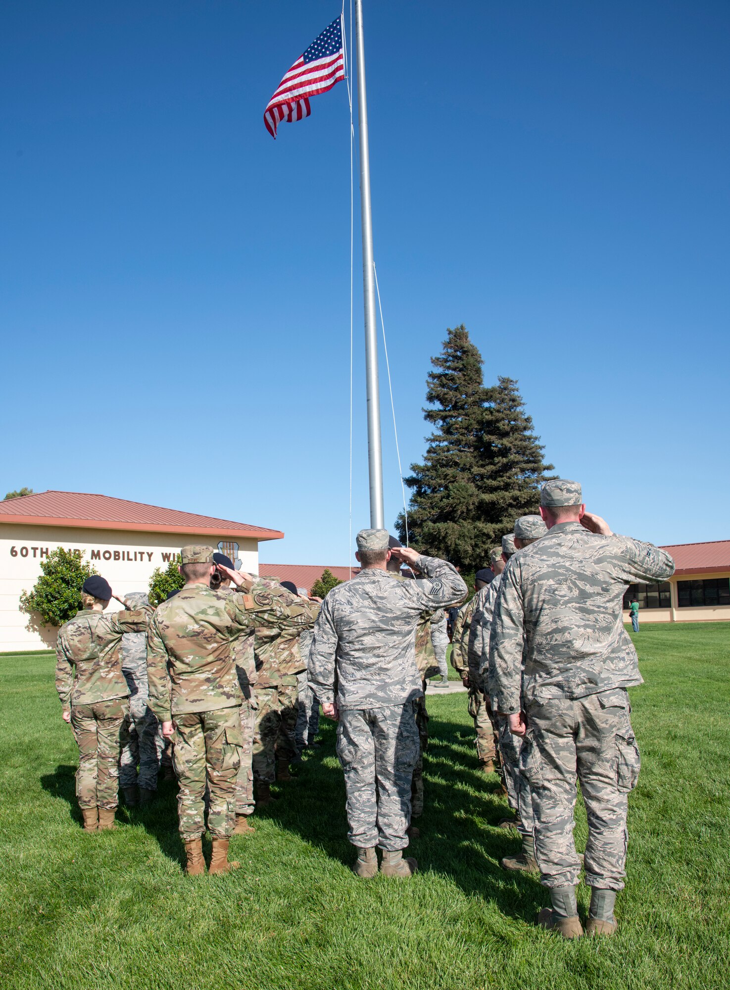 U.S. Air Force first responders from 60th Security Forces Squadron and the 60th Civil Engineer Squadron render a salute during a 9/11 Memorial Retreat Ceremony Sept. 11, 2019, at Travis Air Force Base, California. The ceremony honored the victims of the terrorist attacks on Sept. 11, 2001 and the first responders who risked their lives to save them. (U.S. Air Force photo by Heide Couch)