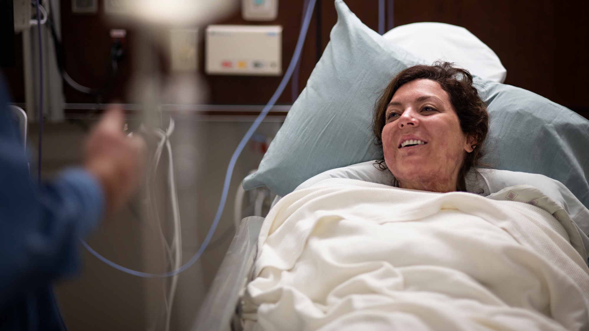 Retired U.S. Army Capt. Katie Blanchard speaks with a nurse before surgery Sept. 6 at Wilford Hall Ambulatory Surgical Center, Joint Base San Antonio-Lackland. Blanchard was injured in a workplace violence incident that left third degree burns on her face, head, arms, neck, back and chest.