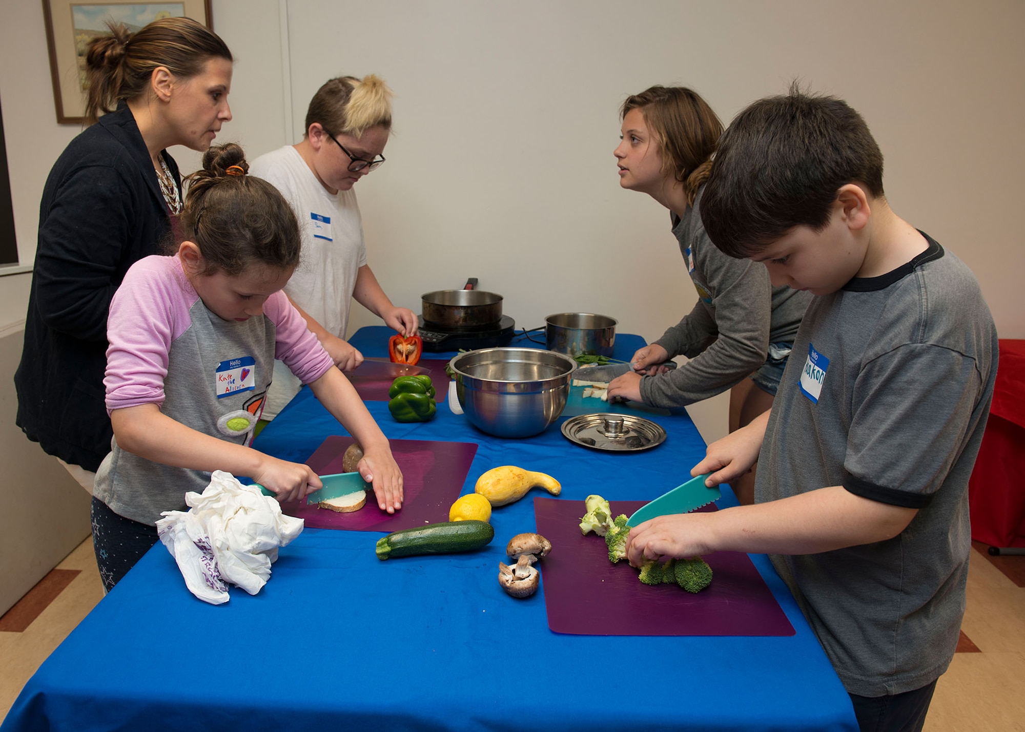 Pictured (far left) Newton guides a team of Jr. Chefs as they prepare food during the Jr. Chef Boot Camp cooking competition. According to founder Alicia Newton, the program is designed to teach the importance of leadership and facilitate healthy relationships.